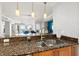 Kitchen with granite countertops offers view of open concept living area and ocean view at 3245 S Atlantic Ave # 304, Daytona Beach Shores, FL 32118