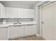 This laundry room features ample storage cabinets, white counters and modern fixtures at 3245 S Atlantic Ave # 304, Daytona Beach Shores, FL 32118
