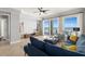 Bright living room with ocean views featuring modern furnishings, ceiling fan, and tile floors at 3245 S Atlantic Ave # 304, Daytona Beach Shores, FL 32118