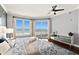 The primary bedroom features windows with ocean views, a fan, and hardwood floors at 3245 S Atlantic Ave # 304, Daytona Beach Shores, FL 32118