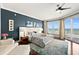 Spacious bedroom with ocean view, ceiling fan, area rug, and private balcony at 3245 S Atlantic Ave # 304, Daytona Beach Shores, FL 32118