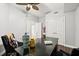 This spacious office features a ceiling fan, bright white walls and dark wood floors at 3245 S Atlantic Ave # 304, Daytona Beach Shores, FL 32118