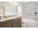 Well-lit bathroom with granite countertop, tile surround, shower and tub at 3322 Modena Way, New Smyrna Beach, FL 32168