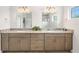 Modern bathroom with double vanity, granite countertops, tile floors, and decorative mirrors at 3322 Modena Way, New Smyrna Beach, FL 32168