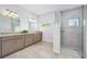 Modern bathroom with double vanity, granite countertops, glass shower, and tile floors at 3322 Modena Way, New Smyrna Beach, FL 32168