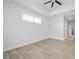 Spacious bedroom with tile floors, neutral walls, large windows and view to the bathroom at 3322 Modena Way, New Smyrna Beach, FL 32168