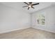 Bright bedroom with a ceiling fan, stylish tiled floors and a window with plantation shutters at 3322 Modena Way, New Smyrna Beach, FL 32168