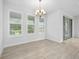 A bright dining room featuring lots of natural light, tile flooring, and a decorative chandelier at 3322 Modena Way, New Smyrna Beach, FL 32168