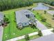Beautifully landscaped home with a paver driveway, lush lawn, and a well-maintained exterior, offering great curb appeal at 3322 Modena Way, New Smyrna Beach, FL 32168