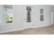 Elegant foyer with decorative glass door and large windows, providing natural light and charm at 3322 Modena Way, New Smyrna Beach, FL 32168