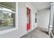 Close up of the entry with a red door and stone accents, offering curb appeal at 3322 Modena Way, New Smyrna Beach, FL 32168