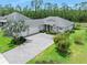Well maintained front yard with a paver driveway and lush green lawn at 3322 Modena Way, New Smyrna Beach, FL 32168