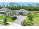 Beautifully landscaped front yard with paver driveway and mature palm tree at 3322 Modena Way, New Smyrna Beach, FL 32168