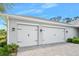 Spacious two-car garage with white doors and black hardware, providing ample parking at 3322 Modena Way, New Smyrna Beach, FL 32168