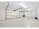 Spacious and well-lit three-car garage with epoxy flooring and automatic door openers at 3322 Modena Way, New Smyrna Beach, FL 32168