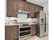 Updated kitchen featuring stainless steel appliances, subway tile backsplash, and wood cabinetry at 3322 Modena Way, New Smyrna Beach, FL 32168