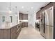 The kitchen includes stainless steel appliances, granite countertops, wood cabinets and recessed lighting at 3322 Modena Way, New Smyrna Beach, FL 32168