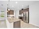 Bright kitchen features granite countertops, stainless steel appliances, and wood cabinets at 3322 Modena Way, New Smyrna Beach, FL 32168