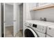 Bright laundry room with washer and dryer hookups and wire shelving at 3322 Modena Way, New Smyrna Beach, FL 32168