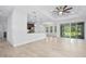 Open living room featuring tile floors, tray ceilings, and sliding glass doors to the patio at 3322 Modena Way, New Smyrna Beach, FL 32168