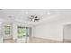 Bright living room with tile floors, a ceiling fan, and sliding doors that lead to a screened-in patio at 3322 Modena Way, New Smyrna Beach, FL 32168