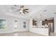 Open-concept living room featuring hardwood floors, recessed lighting, and views into the kitchen at 3322 Modena Way, New Smyrna Beach, FL 32168
