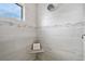 Walk in shower with built-in seat features gray and white tile and chrome shower head at 3322 Modena Way, New Smyrna Beach, FL 32168