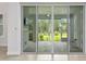 Sliding glass doors offering access to an outdoor covered screened patio with TV at 3322 Modena Way, New Smyrna Beach, FL 32168