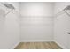An empty walk-in closet features custom shelving, tile floors, and white walls at 3322 Modena Way, New Smyrna Beach, FL 32168