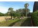 Landscaped backyard with mature trees and a view of the golf course at 340 Hampton Hills Ct, Debary, FL 32713