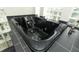 Modern bathroom featuring a sleek black jacuzzi tub and stylish glass block window for natural light at 340 Hampton Hills Ct, Debary, FL 32713