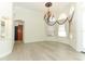 Elegant foyer with chandelier, hardwood floors, arched windows and decorative glass front door at 340 Hampton Hills Ct, Debary, FL 32713