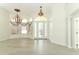 Elegant foyer with chandelier, hardwood floors, arched windows and decorative glass front door at 340 Hampton Hills Ct, Debary, FL 32713