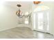 Elegant foyer with a decorative chandelier, large windows, and light wood-look flooring at 340 Hampton Hills Ct, Debary, FL 32713