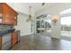 Bright kitchen area with wooden cabinets, granite countertops, stainless steel appliances, and large windows at 340 Hampton Hills Ct, Debary, FL 32713