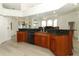 Open kitchen area with dark granite countertops, wood cabinetry, and modern appliances at 340 Hampton Hills Ct, Debary, FL 32713