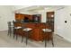 Kitchen island with bar seating, dark countertops, and ample cabinet space with light wood flooring at 340 Hampton Hills Ct, Debary, FL 32713