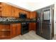 Well-equipped kitchen with stainless steel refrigerator, updated backsplash, and wood cabinets at 340 Hampton Hills Ct, Debary, FL 32713