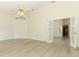 Living room with ceiling fan, white walls, light floors, and a doorway at 340 Hampton Hills Ct, Debary, FL 32713
