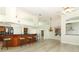 Open-concept living space with kitchen island, bar seating, and light wood floors at 340 Hampton Hills Ct, Debary, FL 32713