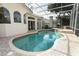 Screened-in pool with attached spa and surrounding brick patio at 340 Hampton Hills Ct, Debary, FL 32713