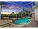 Sparkling pool with jacuzzi and waterfall feature surrounded by a screened enclosure at 340 Hampton Hills Ct, Debary, FL 32713