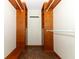 Walk-in closet features wooden shelving and drawers at 340 Hampton Hills Ct, Debary, FL 32713