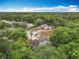 Aerial view featuring two homes with mature landscaping, solar panels, and a pool at 400 Landress Ln, Deland, FL 32724