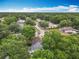 Aerial view of a home featuring a screened lanai and a mature tree canopy at 400 Landress Ln, Deland, FL 32724