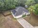 Aerial view of a home with a screened-in pool, fenced yard, solar panels, and a long driveway at 400 Landress Ln, Deland, FL 32724