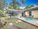 Spacious backyard with a patio area, screened pool, and storage shed, ideal for outdoor activities at 400 Landress Ln, Deland, FL 32724