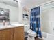 Well-lit bathroom features a shower, vanity, modern fixtures and a stylish, floral-patterned shower curtain at 400 Landress Ln, Deland, FL 32724