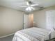 Bedroom features neutral walls, a ceiling fan, a double closet and entry to another room at 400 Landress Ln, Deland, FL 32724