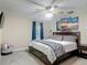 Bedroom showcases stylish bedding, ceiling fan and ocean-themed wall art at 400 Landress Ln, Deland, FL 32724